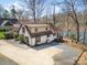 Aerial view of lakefront home with a large driveway and well-maintained yard at 353 Whippoorwill Rd, Mooresville, NC 28117