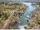 Aerial view showcases the property's waterfront location with its serene waterway and lush surroundings at 353 Whippoorwill Rd, Mooresville, NC 28117