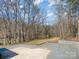 Gravel backyard overlooking mature trees and the lake at 353 Whippoorwill Rd, Mooresville, NC 28117