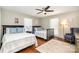 Shared bedroom with two beds, dark wood furnishings, a ceiling fan, and natural light from large windows at 353 Whippoorwill Rd, Mooresville, NC 28117