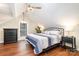 Bedroom with a vaulted ceiling, wood floors, chandelier, and window with a view to the outside at 353 Whippoorwill Rd, Mooresville, NC 28117