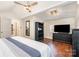 Bedroom with a ceiling fan, view to the backyard, a large dresser, and dark wood floors at 353 Whippoorwill Rd, Mooresville, NC 28117