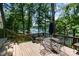 Relaxing deck view with lake view, and black outdoor seating and table under an umbrella at 353 Whippoorwill Rd, Mooresville, NC 28117