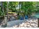 Picturesque waterfront deck with two Adirondack chairs, bench, steps down to the dock and peaceful views of the lake at 353 Whippoorwill Rd, Mooresville, NC 28117