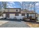 Side exterior view of charming two-story home with a gravel driveway and manicured lawn at 353 Whippoorwill Rd, Mooresville, NC 28117
