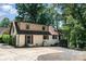 Two-story home exterior with manicured lawn, concrete driveway and brick accents, surrounded by mature trees at 353 Whippoorwill Rd, Mooresville, NC 28117