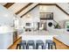Open kitchen with stainless steel appliances, a center island with seating, and a view of the living room and upstairs loft at 353 Whippoorwill Rd, Mooresville, NC 28117