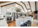 Open-concept kitchen with a large island, stainless steel appliances, exposed beams, fireplace, and hardwood floors at 353 Whippoorwill Rd, Mooresville, NC 28117