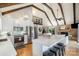 Bright, modern kitchen with white cabinets, stainless steel appliances and large island with seating, plus vaulted ceiling with beams at 353 Whippoorwill Rd, Mooresville, NC 28117