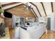Open living room featuring wood accent walls, vaulted ceiling, fireplace, sliding glass doors and access to the kitchen at 353 Whippoorwill Rd, Mooresville, NC 28117