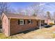 A well-maintained brick house featuring classic black shutters and a welcoming front porch at 3617 12Th Street Ne Dr, Hickory, NC 28601