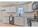 Updated kitchen features white cabinets, stainless steel appliances, and granite countertops at 3617 12Th Street Ne Dr, Hickory, NC 28601