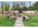 Landscaped backyard with a stone fire pit, stepping stones, and a charming shed, ideal for relaxation at 4053 Crestview Dr, Rock Hill, SC 29732