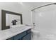 Modern bathroom with blue vanity, floating sink and shower and tub combo at 4053 Crestview Dr, Rock Hill, SC 29732