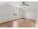Spacious bedroom with hardwood floors, white walls, a ceiling fan, and a window overlooking the outdoors at 4053 Crestview Dr, Rock Hill, SC 29732