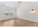 Bright bedroom features wood-look flooring, white walls, and a window with white blinds at 4053 Crestview Dr, Rock Hill, SC 29732