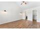 Spacious bedroom featuring wood-look flooring, sconce lighting, and entry to a closet and bathroom at 4053 Crestview Dr, Rock Hill, SC 29732