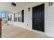 Inviting covered front porch with a dark front door, black lighting and white columns at 4053 Crestview Dr, Rock Hill, SC 29732