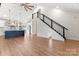 Bright living room with modern staircase and open floor plan flowing into a stylish kitchen with an island at 4053 Crestview Dr, Rock Hill, SC 29732