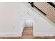 Small entrance to playroom underneath the stairs with hardwoods and white molding at 4053 Crestview Dr, Rock Hill, SC 29732