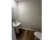 Powder room with pedestal sink and luxury vinyl plank flooring at 4116 Lurelin Ln, Charlotte, NC 28262