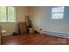 Unfurnished bedroom with vinyl floors, two windows, and a heater at 4343 Saluda Rd, Rock Hill, SC 29730