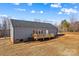 Rear home exterior with a wooden deck, sliding glass doors and low maintenance vinyl siding at 447 Lookout Dam Rd, Statesville, NC 28625