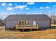 Rear home exterior with a wooden deck, sliding glass doors and low maintenance vinyl siding at 447 Lookout Dam Rd, Statesville, NC 28625