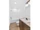 Bathroom with wood style floors, combo tub and shower, and single sink vanity at 447 Lookout Dam Rd, Statesville, NC 28625