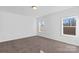 Bedroom with neutral carpet, white walls, and natural light from two windows at 447 Lookout Dam Rd, Statesville, NC 28625