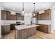 Bright kitchen features a large island, stainless steel appliances, and wood flooring at 447 Lookout Dam Rd, Statesville, NC 28625