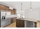 Modern kitchen featuring wood cabinets, granite countertops, stainless steel appliances and views to the dining area at 447 Lookout Dam Rd, Statesville, NC 28625