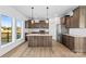 Spacious modern kitchen featuring wood cabinets, granite countertops, stainless steel appliances, and hardwood floors at 447 Lookout Dam Rd, Statesville, NC 28625