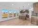 Modern kitchen with wood cabinets, stainless steel appliances, an island, and large windows for natural light at 447 Lookout Dam Rd, Statesville, NC 28625