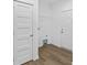 Laundry room with white walls, wood floors, and overhead rack for storage at 447 Lookout Dam Rd, Statesville, NC 28625
