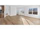Open concept living room featuring wood floors, white walls and trim, and large windows at 447 Lookout Dam Rd, Statesville, NC 28625