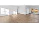 Spacious living room features wood flooring and large windows for ample natural light at 447 Lookout Dam Rd, Statesville, NC 28625