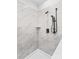Close up of tiled shower with modern fixtures and built-in shelf at 447 Lookout Dam Rd, Statesville, NC 28625