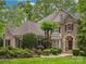 Charming stone and stucco home with manicured landscaping and mature trees at 4687 Eagle Pointe Ct, Denver, NC 28037