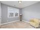 Neutral bedroom featuring natural light, a chair and a floor lamp at 5828 Kelyn Hills Dr, Charlotte, NC 28278