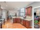 Open kitchen featuring granite countertops, wood cabinets, stainless appliances and hardwood floors at 5828 Kelyn Hills Dr, Charlotte, NC 28278