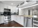 Modern kitchen featuring stainless steel appliances, white cabinetry and tile backsplash at 608 Bubbling Well Rd, Matthews, NC 28105