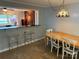 Dining room features tile floors and a counter/bar area looking into another living space at 7107 Wilson Grove Rd, Mint Hill, NC 28227
