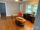Bright living room featuring hardwood floors, a vintage fan, and a view of the exterior at 7107 Wilson Grove Rd, Mint Hill, NC 28227