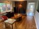Cozy living room with hardwood floors, a brick fireplace, and plenty of natural light at 7107 Wilson Grove Rd, Mint Hill, NC 28227