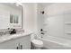 Modern bathroom featuring a granite vanity, sleek fixtures, and a bright window with natural light at 7124 Lake Dr, Matthews, NC 28104