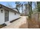 Exterior side view showing driveway, landscaping, and home entrance at 7124 Lake Dr, Matthews, NC 28104