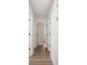 The hallway features wood-look flooring, white walls, and white doors with black hardware at 7124 Lake Dr, Matthews, NC 28104