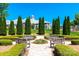 Charming community garden with benches, manicured landscaping, and beautiful flowering plants under a bright blue sky at 786 Platinum Dr, Fort Mill, SC 29708