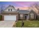 Charming brick home with a well-manicured lawn and attached two-car garage, complemented by a beautiful sunset backdrop at 786 Platinum Dr, Fort Mill, SC 29708